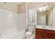 Bathroom featuring a tub, toilet, vanity, and window, creating a functional and well-lit space at 2614 Laurelcherry St, Raleigh, NC 27612