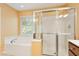 Bright bathroom with bathtub, glass shower, and neutral color scheme at 2614 Laurelcherry St, Raleigh, NC 27612
