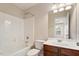 Bathroom with a bathtub/shower combination, toilet, vanity, and large mirror at 2614 Laurelcherry St, Raleigh, NC 27612