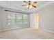 Well-lit bedroom with large windows and a ceiling fan at 2614 Laurelcherry St, Raleigh, NC 27612