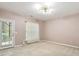 Cozy bedroom with neutral walls, large window, and door to outside offers a relaxing retreat at 2614 Laurelcherry St, Raleigh, NC 27612