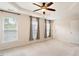 Bright bedroom with plush carpet, three windows, a ceiling fan, and neutral walls at 2614 Laurelcherry St, Raleigh, NC 27612