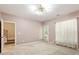 Cozy bedroom with neutral walls, large window, and door to outside offers a relaxing retreat at 2614 Laurelcherry St, Raleigh, NC 27612