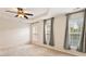 Spacious bedroom featuring a ceiling fan, plush carpet, and multiple windows for natural light at 2614 Laurelcherry St, Raleigh, NC 27612