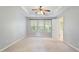 Neutral bedroom with a ceiling fan, three windows, and carpet flooring at 2614 Laurelcherry St, Raleigh, NC 27612