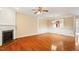 Spacious living room boasts fireplace, hardwood floors, and a kitchen view at 2614 Laurelcherry St, Raleigh, NC 27612