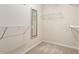 A walk-in closet with neutral carpet, a mirror and multiple levels of white, wire shelving at 2614 Laurelcherry St, Raleigh, NC 27612