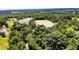 Aerial view of multiple barns and a field surrounded by a dense forest at 2642 Holly Springs Church Rd, Broadway, NC 27505