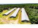 Aerial view of a property featuring several agricultural buildings, revealing their layout and surroundings at 2642 Holly Springs Church Rd, Broadway, NC 27505