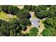 Aerial view of a home featuring a backyard deck surrounded by mature trees and foliage at 2642 Holly Springs Church Rd, Broadway, NC 27505