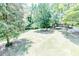 Expansive backyard featuring lush greenery, mature trees, and a large grassy area at 2642 Holly Springs Church Rd, Broadway, NC 27505