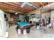 Finished basement with pool table, exposed ceiling, shelving and storage at 2642 Holly Springs Church Rd, Broadway, NC 27505