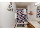 Bathroom featuring a single sink vanity, toilet, and a shower with a patterned curtain at 2642 Holly Springs Church Rd, Broadway, NC 27505