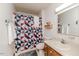 Bathroom featuring a single sink vanity, toilet, and a shower with a patterned curtain at 2642 Holly Springs Church Rd, Broadway, NC 27505