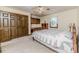 Neutral bedroom with bed, closet, built-ins, and ceiling fan at 2642 Holly Springs Church Rd, Broadway, NC 27505