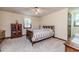 Cozy bedroom featuring neutral walls, carpet flooring, and a decorative wooden bed frame at 2642 Holly Springs Church Rd, Broadway, NC 27505
