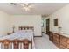 Bright bedroom featuring a bed, closet, ceiling fan and wood furniture at 2642 Holly Springs Church Rd, Broadway, NC 27505