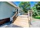 Wooden deck and stairwell area with light green siding on a two-story house at 2642 Holly Springs Church Rd, Broadway, NC 27505