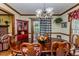 Dining room featuring wood floors, large table and chairs, china cabinet, and large window at 2642 Holly Springs Church Rd, Broadway, NC 27505