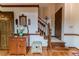 Inviting entryway with hardwood floors, wood trim, staircase and side table with mirror at 2642 Holly Springs Church Rd, Broadway, NC 27505