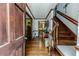 Open entryway featuring hardwood floors, staircase and decorative table with mirror at 2642 Holly Springs Church Rd, Broadway, NC 27505