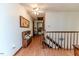Upstairs hallway featuring a wooden bench, wood railing staircase, and wood floors at 2642 Holly Springs Church Rd, Broadway, NC 27505
