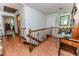 Upstairs hallway with wooden floors, vintage desk and chair and wooden railing at 2642 Holly Springs Church Rd, Broadway, NC 27505