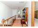 Upstairs hallway with wooden floors, vintage desk and chair and wooden railing at 2642 Holly Springs Church Rd, Broadway, NC 27505