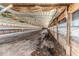 Wide interior of a long barn with equipment and openings along the side walls at 2642 Holly Springs Church Rd, Broadway, NC 27505