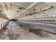 Interior of a large outbuilding with dirt floor, showing the extensive space and overhead fixtures at 2642 Holly Springs Church Rd, Broadway, NC 27505