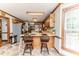 Well-lit kitchen featuring wooden cabinets, tiled floors, and a breakfast bar area at 2642 Holly Springs Church Rd, Broadway, NC 27505