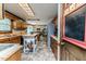 Traditional kitchen with wood cabinets, tiled floors, island with butcher block top, and view of the breakfast nook at 2642 Holly Springs Church Rd, Broadway, NC 27505