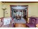 Open living room with hardwood floors, comfortable chairs, and open view to dining room at 2642 Holly Springs Church Rd, Broadway, NC 27505