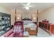A well-furnished main bedroom with a four-poster bed, a sitting chair and carpeted flooring at 2642 Holly Springs Church Rd, Broadway, NC 27505