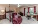Bedroom showcasing a four-poster bed, sitting chair, desk and carpeted flooring at 2642 Holly Springs Church Rd, Broadway, NC 27505