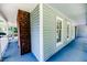 The long porch has blue floors and a brick fireplace at 2642 Holly Springs Church Rd, Broadway, NC 27505