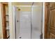 Enclosed white shower area with a chrome shower head and translucent glass door, offering a clean design at 2642 Holly Springs Church Rd, Broadway, NC 27505
