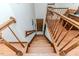View of a wooden staircase with oak trim leading to a door at the bottom of the stairs at 2642 Holly Springs Church Rd, Broadway, NC 27505