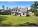 A spacious backyard with lush green lawn, and a view of the house's rear elevation at 2713 Trifle Lane Ln, Wake Forest, NC 27587