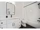 This bright bathroom features black fixtures, sleek white vanity, and a tub with white tiled surround at 2713 Trifle Lane Ln, Wake Forest, NC 27587