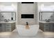 Elegant bathroom features soaking tub, decorative fireplace, and dual vanities for convenience at 2713 Trifle Lane Ln, Wake Forest, NC 27587