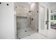 Modern bathroom showcasing a glass-enclosed shower with gray marble tiles and a view to the main bedroom at 2713 Trifle Lane Ln, Wake Forest, NC 27587
