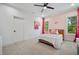 Charming bedroom with a pink accent wall, playful decor, and natural light from a window at 2713 Trifle Lane Ln, Wake Forest, NC 27587