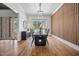 Bright dining room featuring modern lighting, a custom wood accent wall, and an outdoor view at 2713 Trifle Lane Ln, Wake Forest, NC 27587