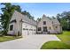 Stunning brick home with a three-car garage and a well-manicured lawn, creating an inviting curb appeal at 2713 Trifle Lane Ln, Wake Forest, NC 27587