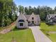 Elegant brick home with manicured front lawn and long driveway, surrounded by mature trees at 2713 Trifle Lane Ln, Wake Forest, NC 27587