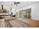 Open-concept living room with a vaulted ceiling, large sliding glass doors, and an adjacent kitchen at 2713 Trifle Lane Ln, Wake Forest, NC 27587