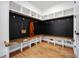 Mudroom with custom bench seating, storage, and a black accent wall with gold hooks at 2713 Trifle Lane Ln, Wake Forest, NC 27587