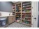 Walk-in pantry with built-in shelving, a mini-fridge, and stylish geometric patterned flooring at 2713 Trifle Lane Ln, Wake Forest, NC 27587