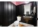 Stylish powder room with dark walls, a unique sink, and eye-catching zebra wallpaper at 2713 Trifle Lane Ln, Wake Forest, NC 27587